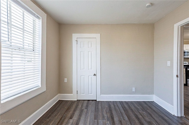 spare room featuring dark hardwood / wood-style floors