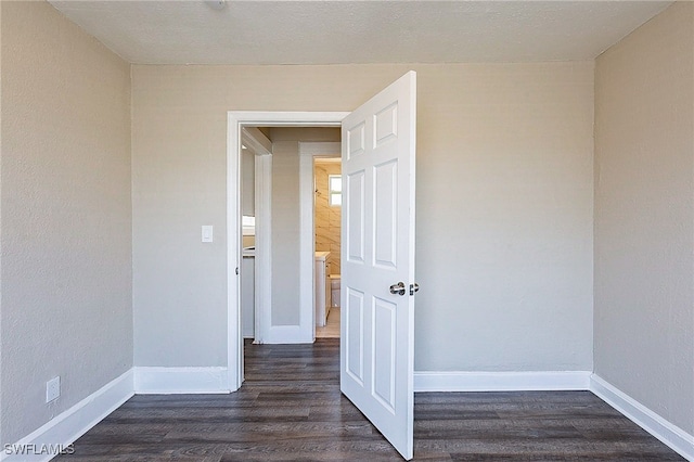 spare room with dark hardwood / wood-style flooring