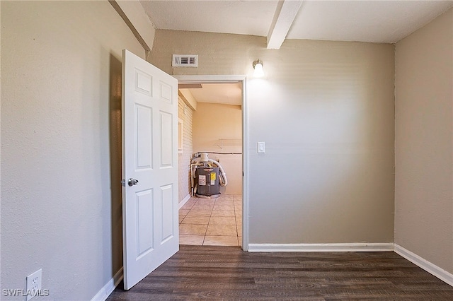 hall with beam ceiling and dark hardwood / wood-style flooring