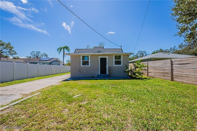 back of house with a yard