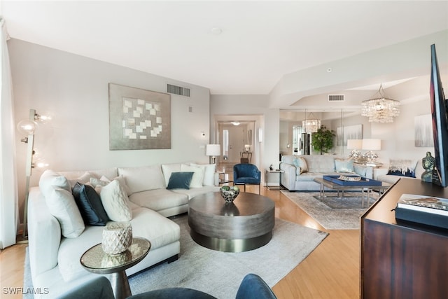 living room with a notable chandelier and hardwood / wood-style floors