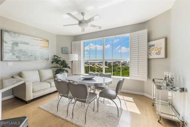 dining space with light hardwood / wood-style flooring and ceiling fan