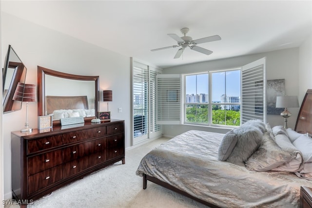 carpeted bedroom featuring access to outside and ceiling fan