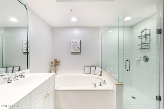 bathroom with vanity and independent shower and bath