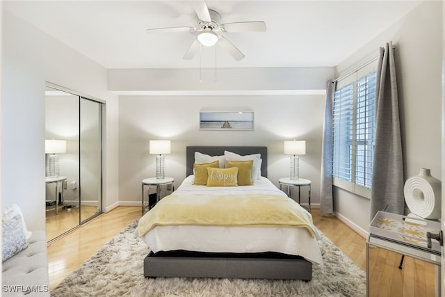 bedroom featuring a closet, light wood-type flooring, and ceiling fan