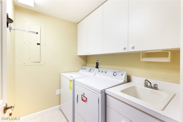 washroom featuring independent washer and dryer, sink, light tile patterned flooring, cabinets, and electric panel