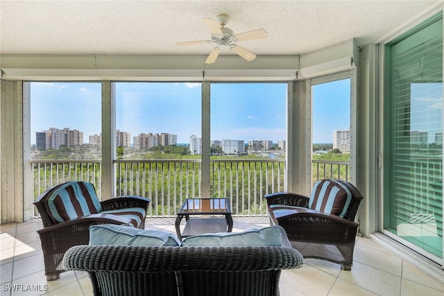 sunroom / solarium with a healthy amount of sunlight and ceiling fan