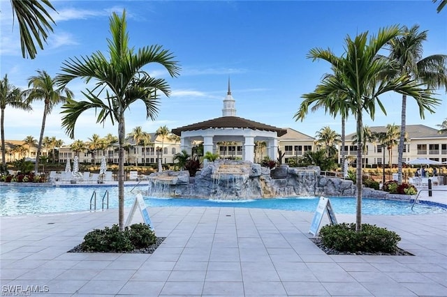 view of pool featuring pool water feature and a patio area