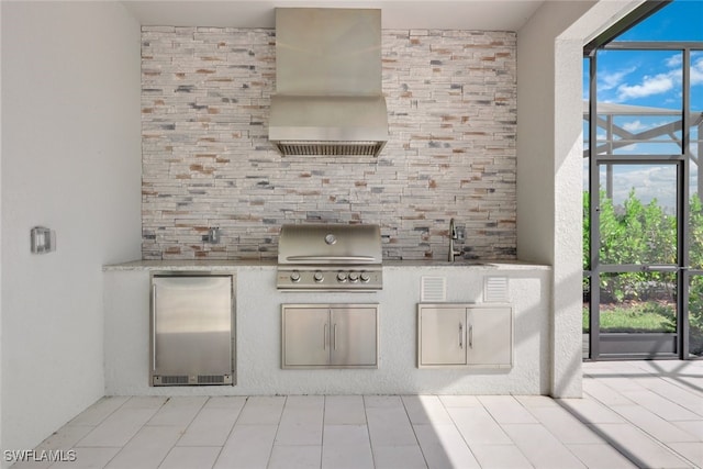 interior space featuring a sink, light countertops, fridge, decorative backsplash, and custom range hood