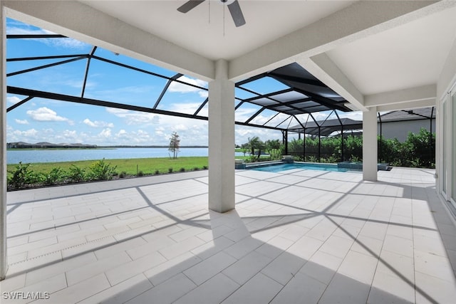 view of pool featuring a water view, a patio area, glass enclosure, and ceiling fan