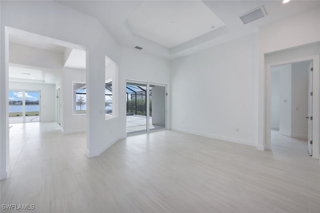 spare room with a tray ceiling