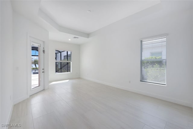 empty room featuring a healthy amount of sunlight and light tile patterned floors