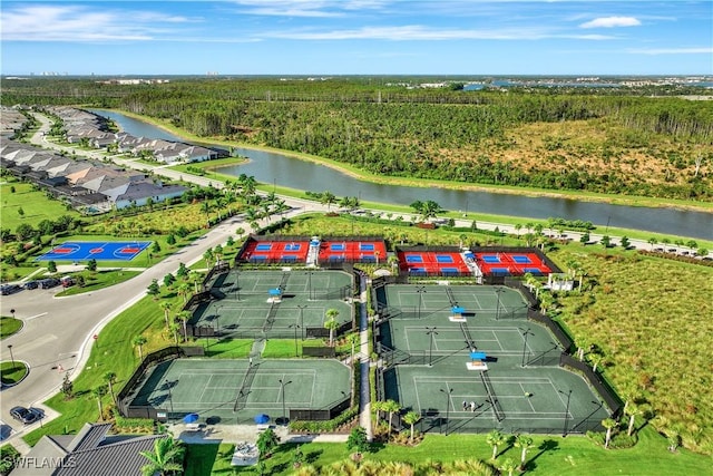 birds eye view of property featuring a water view and a view of trees