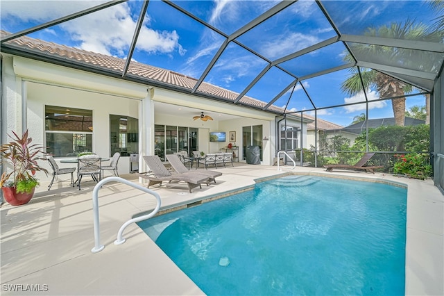 view of pool featuring ceiling fan, a patio, and a lanai