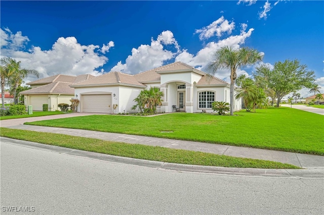 mediterranean / spanish-style house with a garage and a front lawn