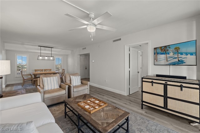 living room featuring ceiling fan and wood-type flooring