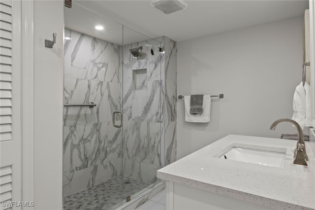 bathroom featuring vanity and a shower with shower door