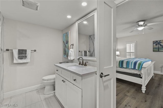 bathroom featuring vanity, toilet, and ceiling fan