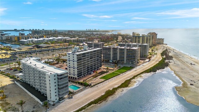 birds eye view of property featuring a view of the beach and a water view