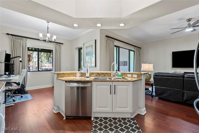 kitchen featuring dark hardwood / wood-style flooring, stainless steel dishwasher, sink, white cabinetry, and hanging light fixtures