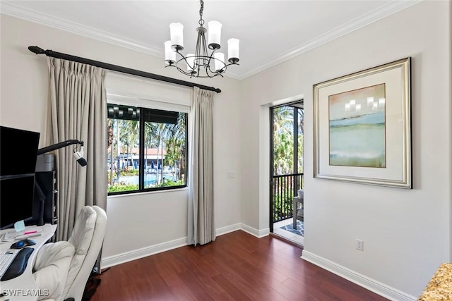 interior space with dark wood-type flooring, an inviting chandelier, a healthy amount of sunlight, and ornamental molding