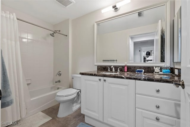 full bathroom featuring tile patterned floors, shower / bath combo with shower curtain, vanity, and toilet