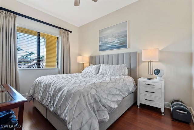 bedroom with dark hardwood / wood-style flooring and ceiling fan