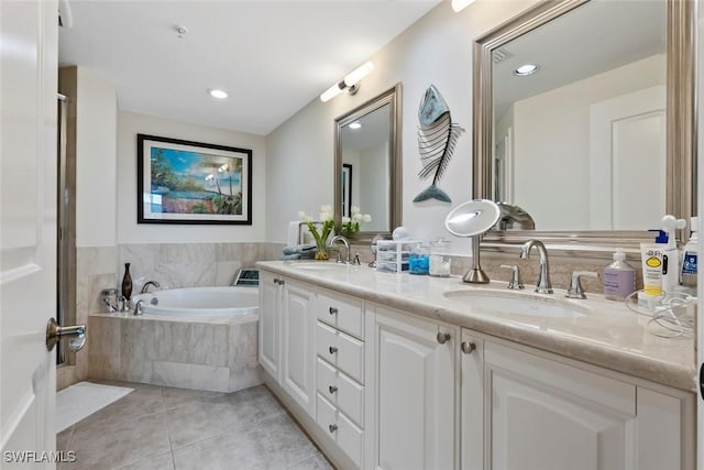 bathroom featuring tile patterned flooring, vanity, and a relaxing tiled tub