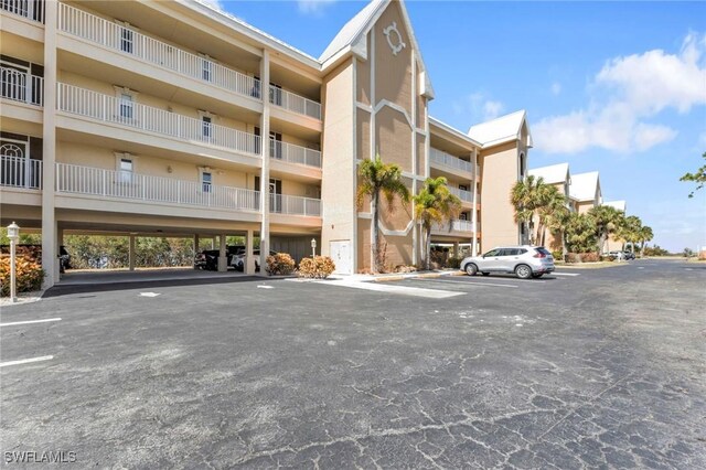 101 N Marion Ct Unit 122, Punta Gorda, FL 33950 - view of apartment building / complex featuring uncovered parking