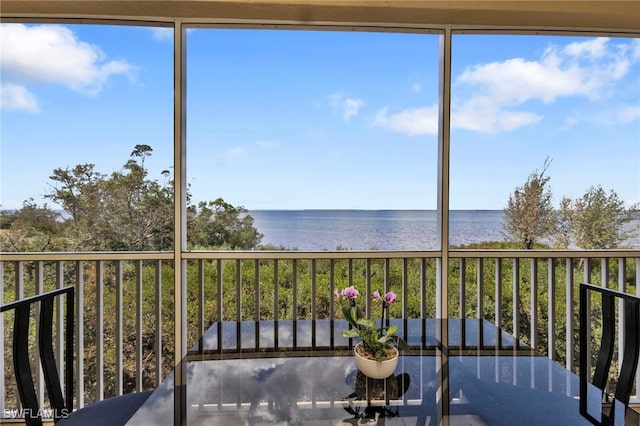 unfurnished sunroom with a water view and a healthy amount of sunlight