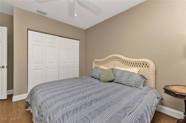 101 N Marion Ct Unit 122, Punta Gorda, FL 33950 - bedroom with a closet, baseboards, wood finished floors, and a ceiling fan