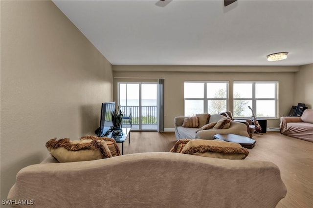 living room featuring light wood-type flooring and baseboards