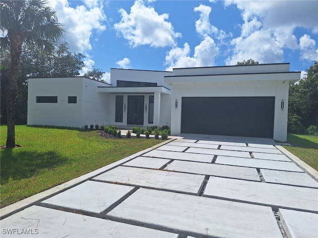 modern home with a front lawn and a garage