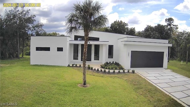 view of front of property with a front lawn and a garage