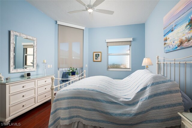 bedroom featuring ceiling fan and dark wood-type flooring