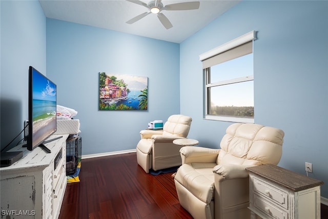 living area with ceiling fan and dark wood-type flooring