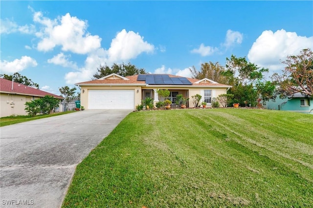 ranch-style house with a garage, a front yard, and solar panels