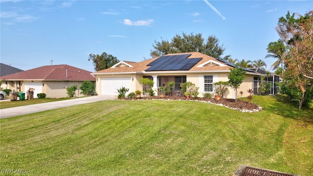 view of front of property with a front yard, solar panels, and a garage