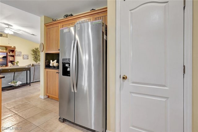 kitchen featuring ceiling fan, light brown cabinets, light tile patterned floors, stainless steel fridge with ice dispenser, and lofted ceiling