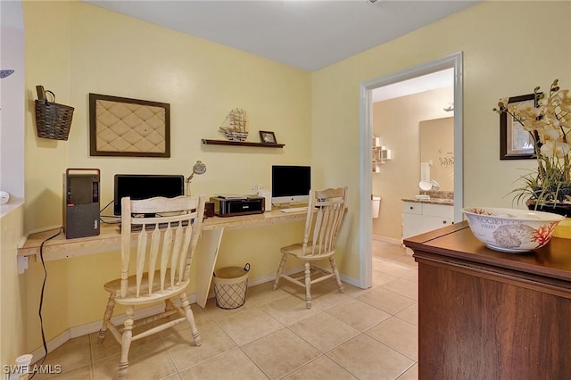 home office with light tile patterned floors and built in desk