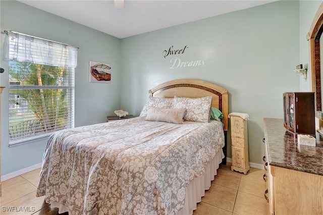 bedroom featuring ceiling fan and light tile patterned flooring