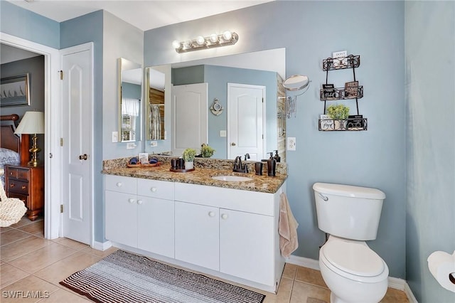 bathroom with tile patterned flooring, vanity, toilet, and a shower with shower door