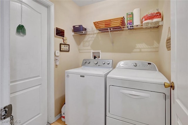 washroom featuring washer and clothes dryer