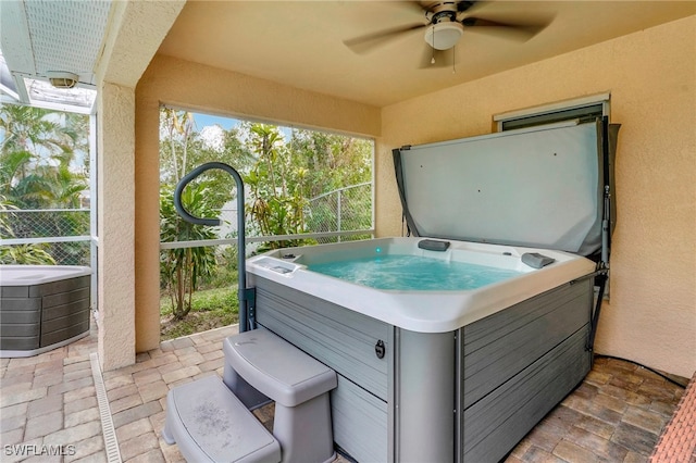 view of patio with a hot tub and ceiling fan