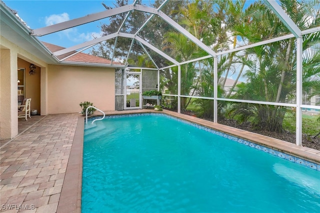 view of pool featuring a patio area and a lanai