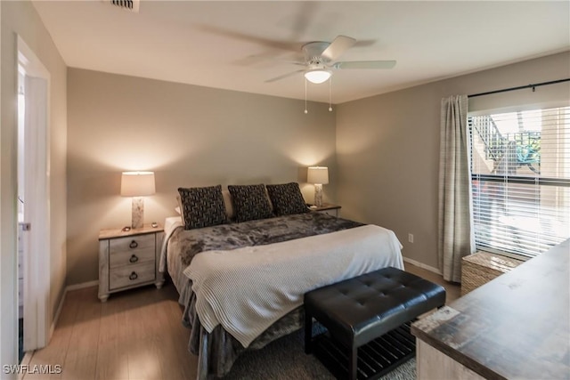 bedroom with ceiling fan and hardwood / wood-style flooring