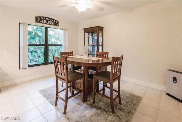 dining area with ceiling fan and light tile patterned floors