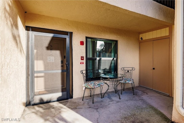 property entrance featuring a patio area