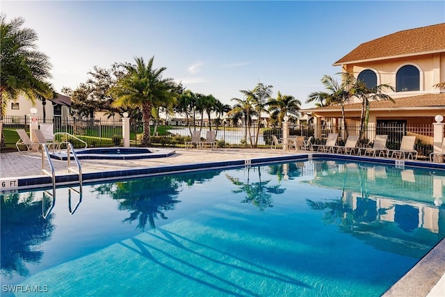 view of swimming pool with a community hot tub and a patio area