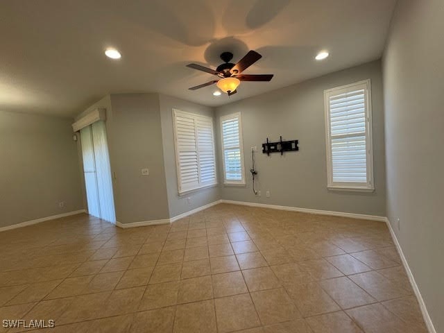 unfurnished room featuring light tile patterned flooring and ceiling fan